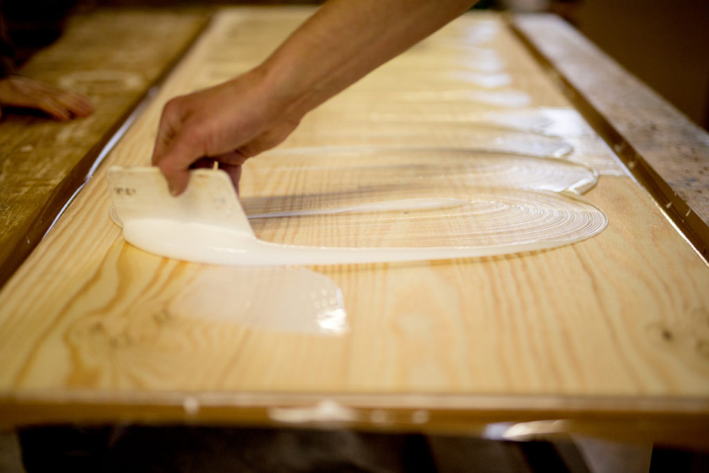 Photograph of glue being applied to wood